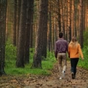 Photo of couple walking in woods from Roman Purtov on Unsplash.